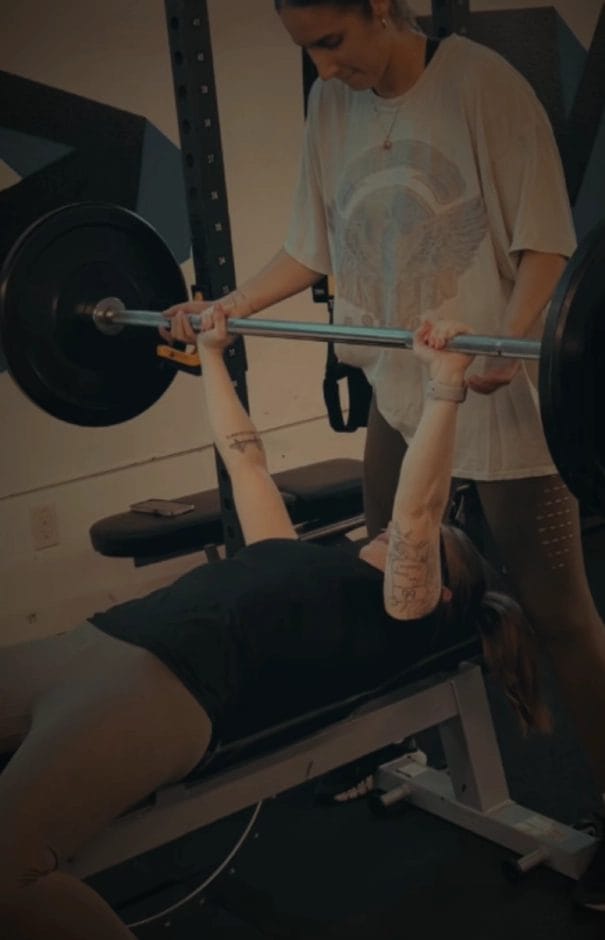 Woman lifting weight on bench at Innovative Strength & Conditioning